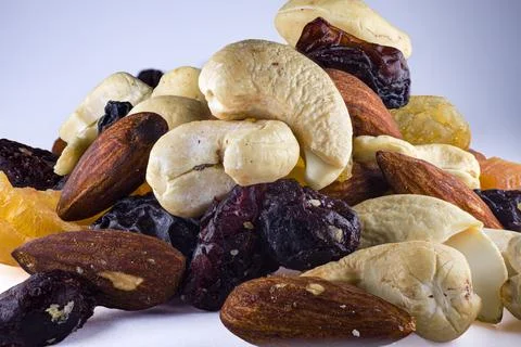 Assorted dried fruit and nuts featuring banana chips, almonds, dates, raisi.. Stock Photos