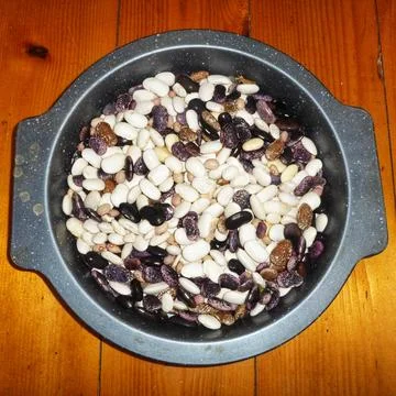 Assorted dried kidney beans mixture in a bowl on wooden surface Stock Photos