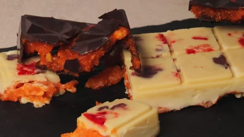 Assorted Dubai Chocolate Bars with Mango Filling on Dark Serving Board, Gourmet Vídeo Stock 312002661