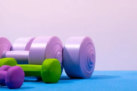 Assorted dumbbells on blue mat 2 Stock Photos