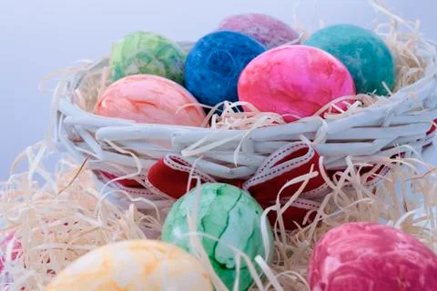 Assorted easter eggs in a wicker basket Stock Photos