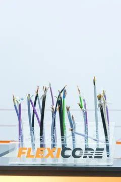Assorted electric cables displayed in a clear plastic stand. Samples of Фото