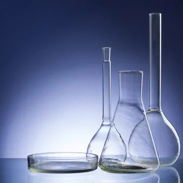 Assorted empty laboratory glassware, test-tubes. Blue tone medical background 库存照片