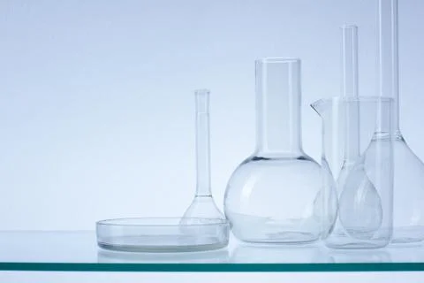 Assorted empty laboratory glassware, test-tubes. Blue tone medical background 库存照片