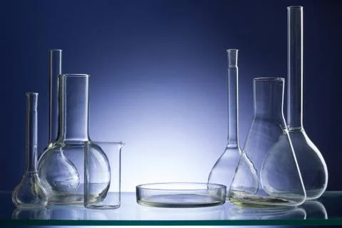 Assorted empty laboratory glassware, test-tubes. Blue tone medical background Stock Photos