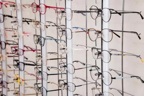 Assorted eyeglasses collection hanging on display rack for sale in optical .. Foto stock