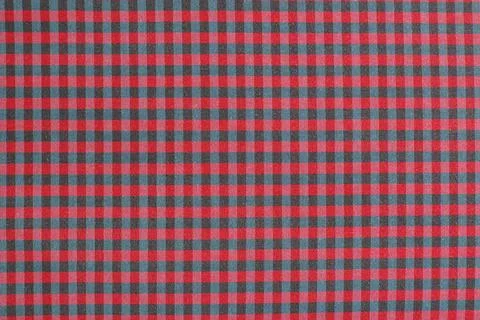 Assorted fabric pieces featuring checkered and striped textures in rich col.. Stock Photos