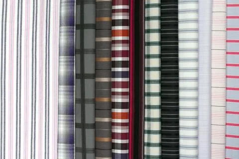 Assorted fabric pieces featuring checkered and striped textures in rich col.. Stock Photos