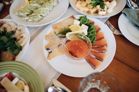 Assorted fish and red caviar on the table in a restaurant at a party Stock Photos