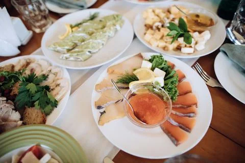 Assorted fish on a plate on a holiday table in a restaurant. Different holida Foto stock