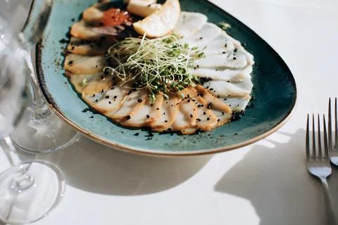 Assorted fish on a plate on the table in a restaurant Stock Photos