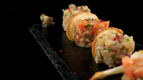 Assorted fish tartar tray with bread toast, loop Video stock 66480392