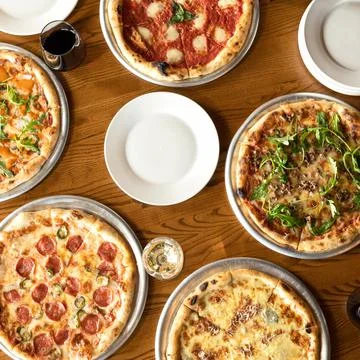 Assorted, five different pizzas on a wooden table. High angle view. Copy space Stock Photos