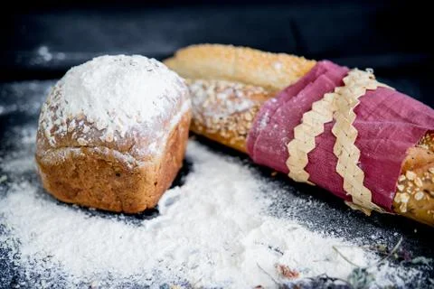Assorted fragrant loaves of bread with flour Stock Photos