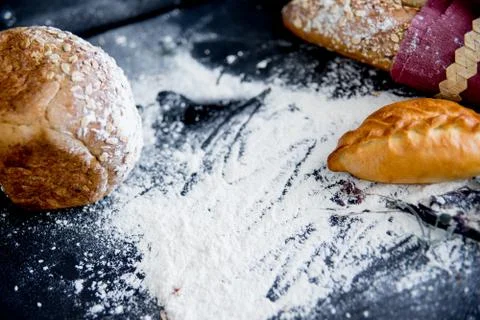 Assorted fragrant loaves of bread with flour Stock Photos