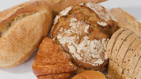 Assorted Fresh Artisan Breads and Pastries on White Background Stock Footage 337925937