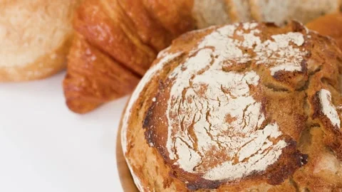 Assorted Fresh Baked Artisanal Breads and Pastries on White Background Stock Footage 338051209