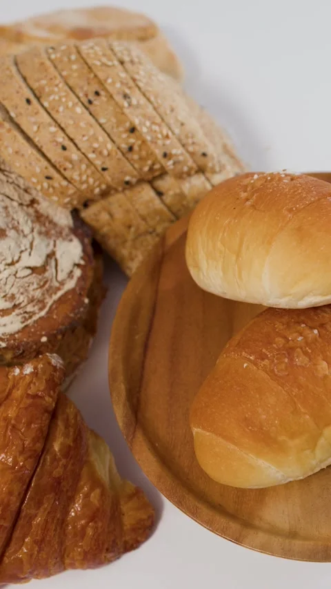 Assorted Fresh Bakery Bread and Pastries on White Background Stock Footage 337995178