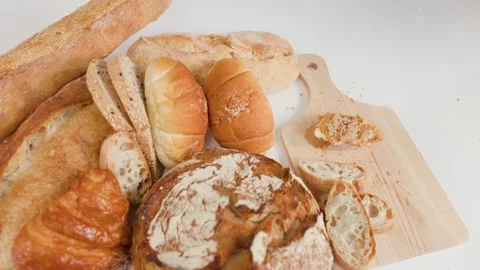 Assorted Fresh Bakery Bread and Pastries on White Background Stock Footage 338051711