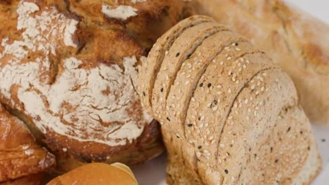 Assorted Fresh Bakery Bread and Pastries on White Background Stock Footage 338053206
