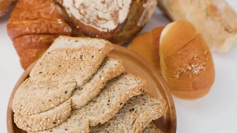 Assorted Fresh Bakery Bread and Pastries Rotating on White Background Stock Footage 338421166