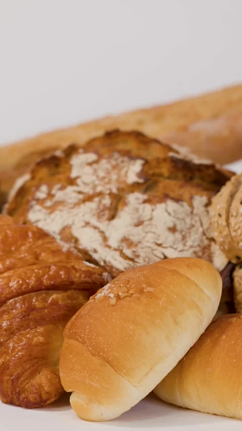 Assorted Fresh Bakery Bread and Pastries on White Background Stock Footage 339518871