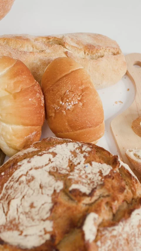 Assorted Fresh Bakery Breads and Pastries on White Background Stock Footage 337394886