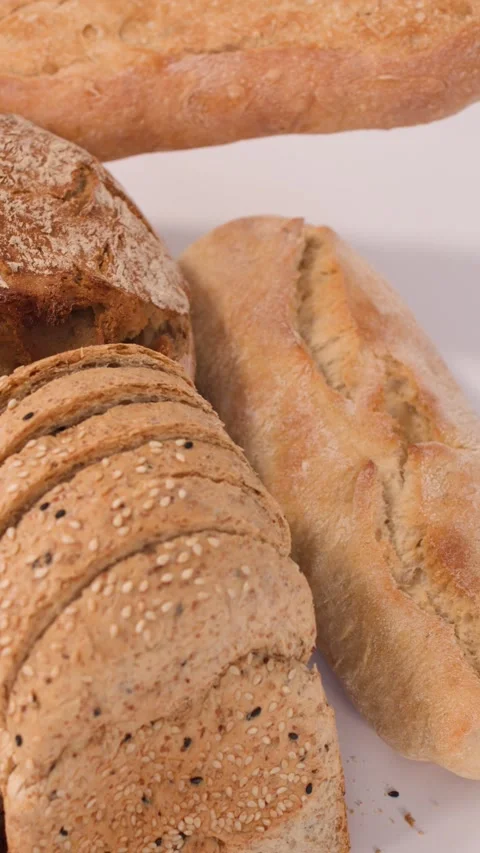 Assorted Fresh Bakery Breads and Pastries on White Background Stock Footage 337519500