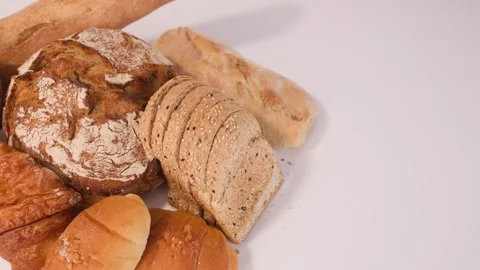 Assorted Fresh Bakery Breads and Pastries Rotating on White Background Stock Footage 337519533