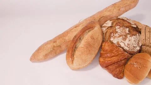 Assorted Fresh Bakery Breads and Pastries on White Background Stock Footage 337519555