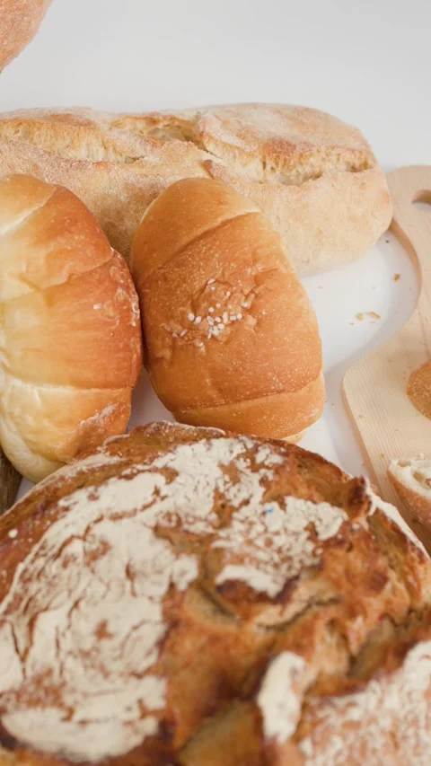 Assorted Fresh Bakery Breads and Pastries on White Background Stock Footage 337520995