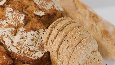 Assorted Fresh Bakery Breads and Pastries on White Background Stock Footage 337757690