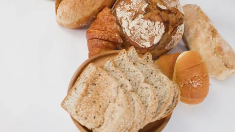 Assorted Fresh Bakery Breads and Pastries on White Background Stock Footage 337876705