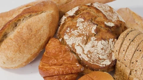 Assorted Fresh Bakery Breads and Pastries on White Background Stock Footage 337917894
