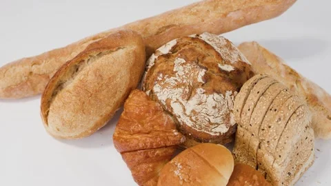 Assorted Fresh Bakery Breads and Pastries on White Background Stock Footage 337917926