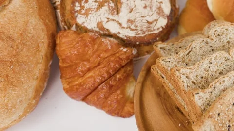 Assorted Fresh Bakery Breads and Pastries on White Background Stock Footage 337925848