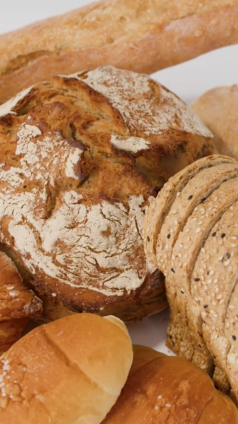 Assorted Fresh Bakery Breads and Pastries on White Background Stock Footage 337997226