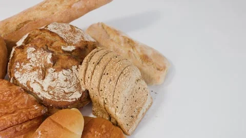 Assorted Fresh Bakery Breads and Pastries on White Background Stock Footage 338041727
