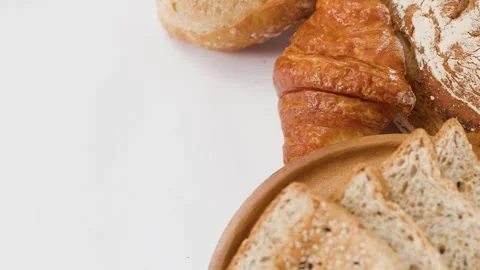 Assorted Fresh Bakery Breads and Pastries on White Background Stock Footage 338041842