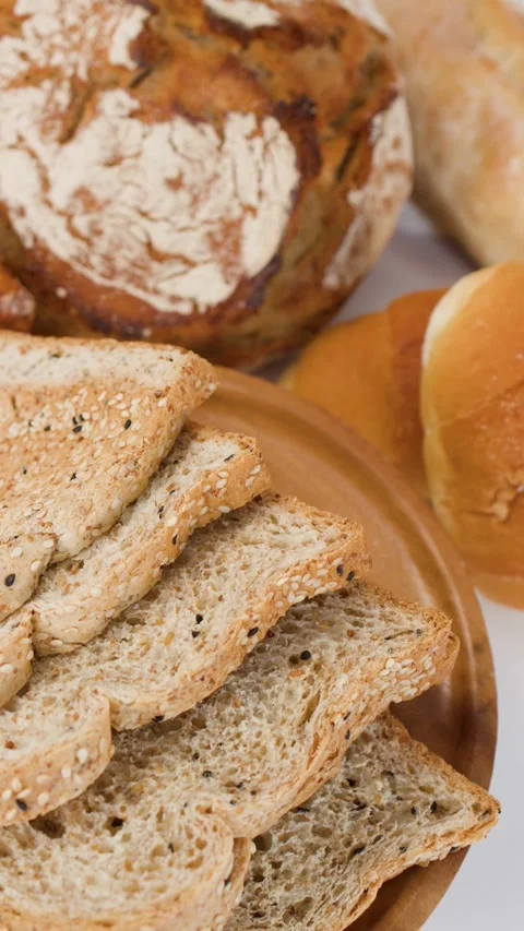 Assorted Fresh Bakery Breads and Sliced Whole Grain Toast Stock Footage 338053013