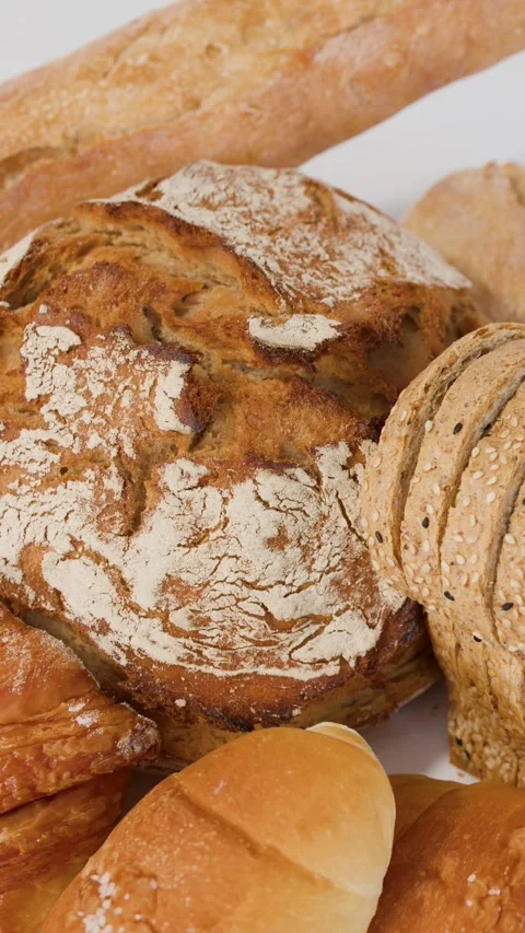 Assorted Fresh Bakery Breads and Pastries on White Background Stock Footage 338053280