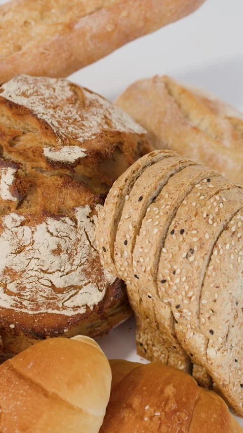 Assorted Fresh Bakery Breads and Pastries on White Background Stock Footage 338053640