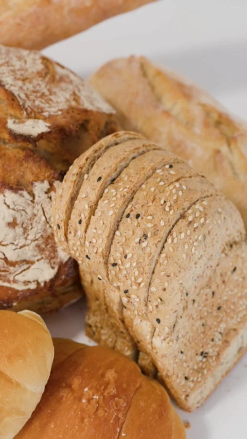 Assorted Fresh Bakery Breads and Pastries on White Background Stock Footage 338054778