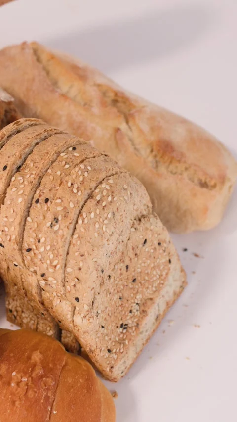 Assorted Fresh Bakery Breads and Pastries on White Background Stock Footage 338326768