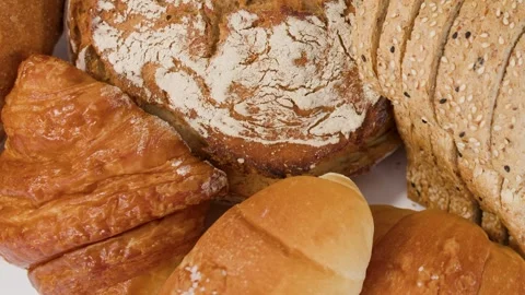 Assorted Fresh Bakery Breads and Pastries on White Background Stock Footage 339124281