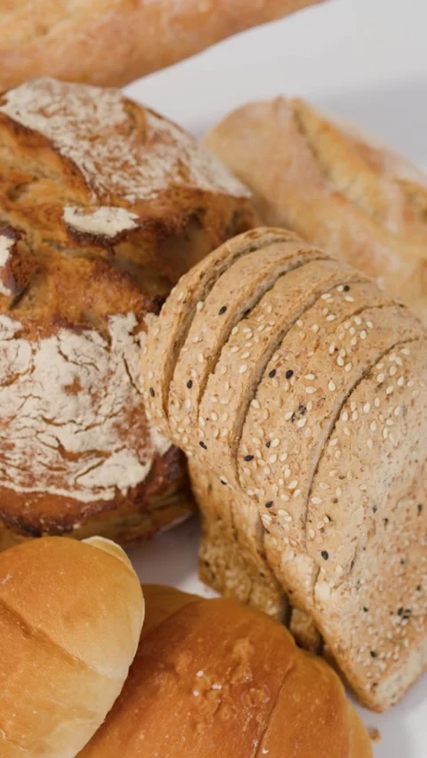 Assorted Fresh Bakery Breads and Pastries on White Background Stock Footage 339514003