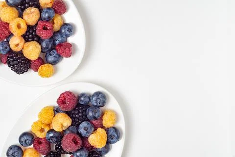 Assorted fresh berries on a white plates Stock Photos