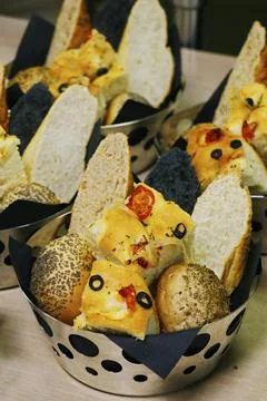 Assorted fresh breads in a metal basket Stock Photos