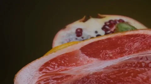 Assorted fresh fruit, grapefruit,splashes of water on fruit, fresh juice Stock Footage 131603689