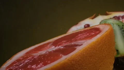 Assorted fresh fruit, grapefruit,splashes of water on fruit, fresh juice Stock Footage 131603795